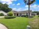 Attractive one-story home with a lush, green lawn and mature landscaping, creating lovely curb appeal at 37147 Foxrun Pl, Zephyrhills, FL 33542