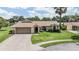 Charming single-story home with a well-manicured lawn and a two-car garage at 37147 Foxrun Pl, Zephyrhills, FL 33542