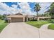 Charming single-story home with well-manicured lawn and attached two-car garage at 37147 Foxrun Pl, Zephyrhills, FL 33542
