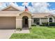 Charming single-Gathering home with manicured landscaping and a welcoming entryway at 37147 Foxrun Pl, Zephyrhills, FL 33542