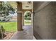 Covered front porch offers shade and a view of the front yard and neighborhood at 37147 Foxrun Pl, Zephyrhills, FL 33542