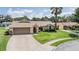 Charming single-story home with an attached two-car garage, mature landscaping, and inviting curb appeal at 37147 Foxrun Pl, Zephyrhills, FL 33542
