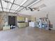 Spacious garage with washer, dryer, storage cabinets, and plenty of room for tools and equipment at 37147 Foxrun Pl, Zephyrhills, FL 33542