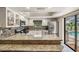 Bright kitchen boasts granite countertops, stainless steel appliances, and a view of the pool at 37147 Foxrun Pl, Zephyrhills, FL 33542