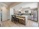 Modern kitchen featuring granite counters, stainless steel appliances, and a breakfast bar at 37147 Foxrun Pl, Zephyrhills, FL 33542