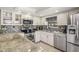 Updated kitchen featuring granite countertops, stainless steel appliances, and stylish backsplash at 37147 Foxrun Pl, Zephyrhills, FL 33542