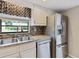 A well-lit kitchen with stainless steel appliances and granite countertops at 37147 Foxrun Pl, Zephyrhills, FL 33542