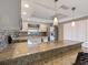 Kitchen with granite counters, stainless steel appliances, pendant lighting, and a breakfast bar at 37147 Foxrun Pl, Zephyrhills, FL 33542