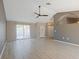 Bright and airy living room featuring vaulted ceilings, neutral paint, and elegant flooring at 37147 Foxrun Pl, Zephyrhills, FL 33542