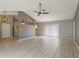 A spacious living room with a ceiling fan, modern flooring, and natural light from sliding glass doors at 37147 Foxrun Pl, Zephyrhills, FL 33542