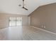 Bright living room featuring sliding glass doors leading to a pool and neutral paint colors at 37147 Foxrun Pl, Zephyrhills, FL 33542