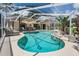 Sparkling screened-in pool with ample seating and lush landscaping at 37147 Foxrun Pl, Zephyrhills, FL 33542