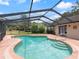 Enclosed pool with a screened enclosure and surrounding deck area at 37147 Foxrun Pl, Zephyrhills, FL 33542