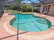 In-ground pool with a screened enclosure featuring a patio area and views of the surrounding landscape at 37147 Foxrun Pl, Zephyrhills, FL 33542