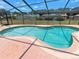 Refreshing in-ground pool surrounded by a screened enclosure and ample patio space at 37147 Foxrun Pl, Zephyrhills, FL 33542