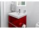 Modern bathroom featuring a red vanity with a white sink and chrome fixtures at 4050 4Th N St # 116, St Petersburg, FL 33703
