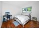 Bedroom with a window, wood floors, and a bed with white linens at 4050 4Th N St # 116, St Petersburg, FL 33703