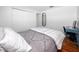 Bedroom with wood floors, a white and gray bedspread, and a desk at 4050 4Th N St # 116, St Petersburg, FL 33703