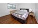 Well-lit bedroom featuring wood floors and a floral patterned bed spread at 4050 4Th N St # 116, St Petersburg, FL 33703
