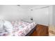 Bright bedroom with wood floors, a floral-patterned bedspread, and white walls at 4050 4Th N St # 116, St Petersburg, FL 33703