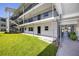 Exterior of the building with well-maintained grass and pathway access at 4050 4Th N St # 116, St Petersburg, FL 33703