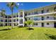 Exterior of condo building highlighting well-manicured lawn, stairs and balconies at 4050 4Th N St # 116, St Petersburg, FL 33703