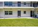 Exterior view of the condo featuring ground floor access and well-kept lawn at 4050 4Th N St # 116, St Petersburg, FL 33703