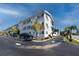 Exterior of condo showcasing brick facade, palm trees, and well maintained grounds at 4050 4Th N St # 116, St Petersburg, FL 33703