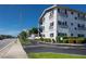 Well-maintained condominium building with brick facade, black shutters, and mature trees at 4050 4Th N St # 116, St Petersburg, FL 33703