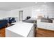 Bright kitchen island with white quartz countertop, stainless steel sink, and modern appliances, open to the living area at 4050 4Th N St # 116, St Petersburg, FL 33703