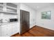 Modern kitchen features stainless steel appliances, ample white cabinetry, and wood flooring, creating a clean and functional space at 4050 4Th N St # 116, St Petersburg, FL 33703
