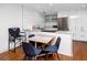 Modern kitchen features white cabinets, stainless steel appliances, and a cozy breakfast nook with seating for four at 4050 4Th N St # 116, St Petersburg, FL 33703