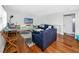 Cozy living room featuring a plush navy sofa, a stylish rug, and a view of a beach-themed entertainment setup at 4050 4Th N St # 116, St Petersburg, FL 33703