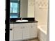 Bathroom featuring a granite vanity with white cabinets, tile floors and shower at 410 S Armenia Ave # 926, Tampa, FL 33609