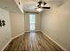 Bedroom features wood-look flooring, a ceiling fan, window with blinds, and TV mount at 410 S Armenia Ave # 926, Tampa, FL 33609