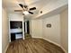Bedroom showcasing wood-look flooring, ceiling fan, and custom built-in desk and shelving at 410 S Armenia Ave # 926, Tampa, FL 33609