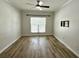 Bedroom features wood-look floors, a ceiling fan, window with blinds, and TV mount at 410 S Armenia Ave # 926, Tampa, FL 33609