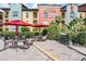 Outdoor common area offers comfortable seating, red umbrellas, lush landscaping, and a grill at 410 S Armenia Ave # 926, Tampa, FL 33609
