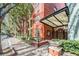 The building entrance features a covered walkway, landscaping and brick pavers at 410 S Armenia Ave # 926, Tampa, FL 33609