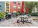 A well-equipped outdoor grilling area with picnic tables and umbrellas perfect for community gatherings and barbecues at 410 S Armenia Ave # 926, Tampa, FL 33609