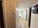 Hallway featuring a smart thermostat and wood-look flooring leading to the kitchen and bedrooms at 410 S Armenia Ave # 926, Tampa, FL 33609