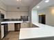 Modern kitchen with stainless steel appliances, white cabinets, and granite countertops at 410 S Armenia Ave # 926, Tampa, FL 33609