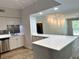 Bright kitchen features white cabinets, modern appliances, mosaic backsplash, and bar seating area at 410 S Armenia Ave # 926, Tampa, FL 33609