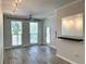 Sunlit living room with wood floors, a ceiling fan, and bright, neutral walls at 410 S Armenia Ave # 926, Tampa, FL 33609