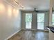 Bright living room featuring wood floors, a ceiling fan, and large windows for natural light at 410 S Armenia Ave # 926, Tampa, FL 33609