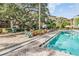 Community pool with multiple seating options, landscaping, and an inviting atmosphere for relaxation and enjoyment at 410 S Armenia Ave # 926, Tampa, FL 33609