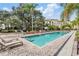 Community pool area with deck chairs and lush landscaping offers a resort-style living experience at 410 S Armenia Ave # 926, Tampa, FL 33609