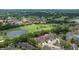 Aerial view of property nestled next to a golf course and pond in a lush community at 4213 Arborwood Ln, Tampa, FL 33618