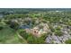 Aerial view of property adjacent to pond and golf course in established community at 4213 Arborwood Ln, Tampa, FL 33618