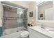 Modern bathroom with tiled shower and glass door, featuring a sleek vanity and fixtures at 4213 Arborwood Ln, Tampa, FL 33618